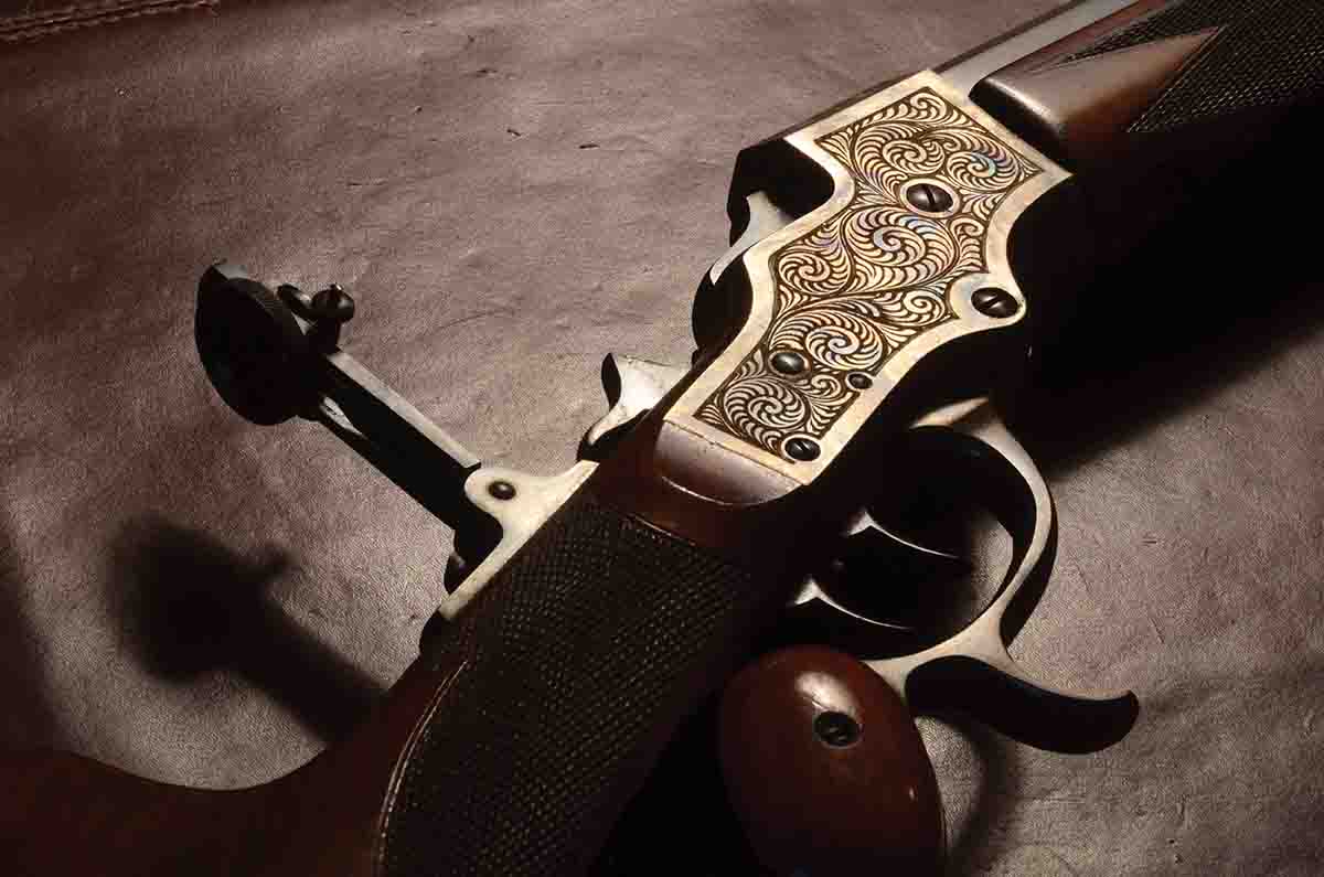 This Stevens Model 51 Schützen rifle (.32-40) was made around 1900, bearing the standard engraving of that grade. The pattern is simple and uncomplicated, but it serves the purpose of breaking up the flat surface, holding oil and making the rifle highly attractive.